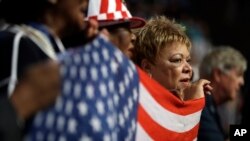 FILE - Florida delegates hold up a flag during the third day session of the Democratic National Convention in Philadelphia, July 27, 2016. Democratic activists on the state level have been complaining about a lack of funding coming from the national committee.