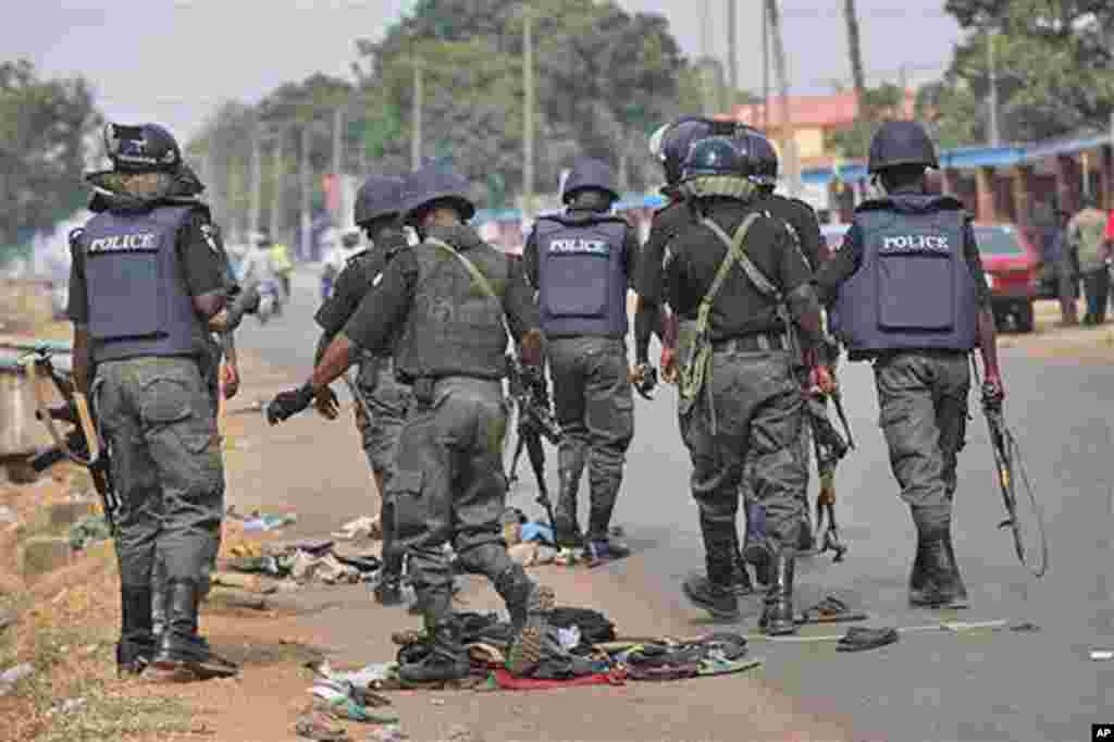 Police officers patrol outside the court, where suspected rioters awaited a court hearing in Kaduna, Nigeria.