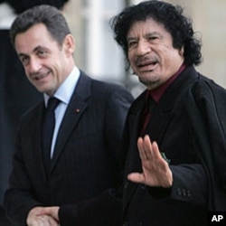 French President Nicolas Sarkozy greets Libyan leader Moammar Gadhafi at his arrival at the Elysee Palace in Paris, December 12, 2007.