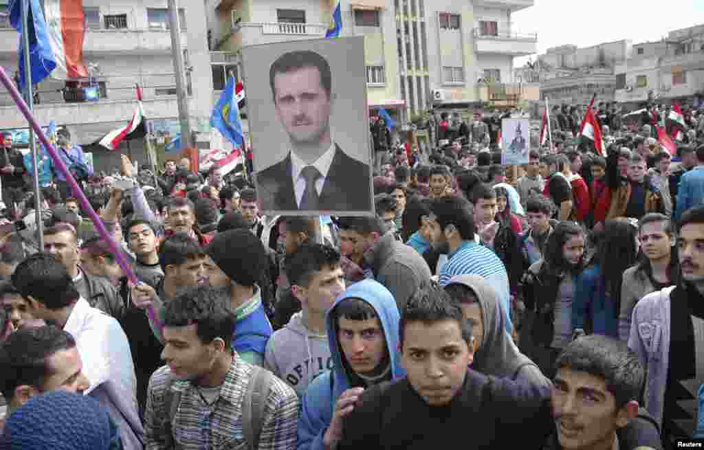 Supporters of Syrian President Bashar al-Assad rally in Homs, Feb. 11, 2014, in this handout photograph released by SANA.