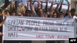 Syrians flashing the victory sign during an anti-regime demonstration in Hass in the restive northern province of Idlib on June 8, 2012.