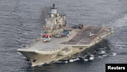FILE - A photo taken from a Norwegian surveillance aircraft shows Russian aircraft carrier Admiral Kuznetsov in international waters off the coast of northern Norway, Oct.17, 2016.