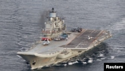 FILE - A photo taken from a Norwegian surveillance aircraft shows the Russian aircraft carrier Admiral Kuznetsov in international waters off the coast of northern Norway, Oct. 17, 2016.