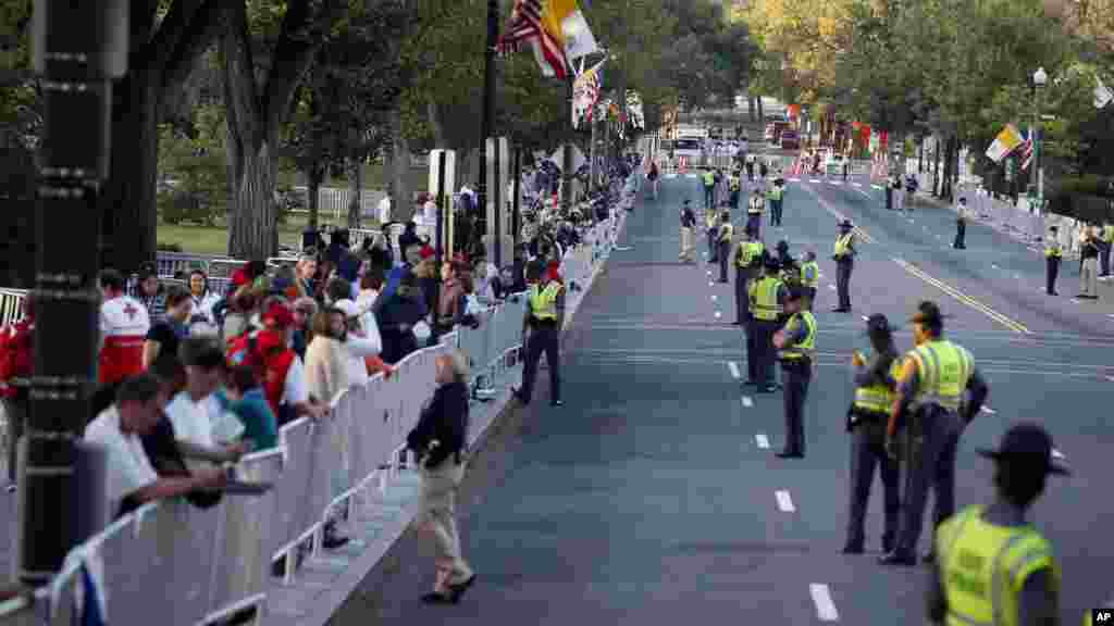 Une foule et des agents de sécurité postés le long de l&#39;itinéraire papale attendent sur la 17e rue en face de Constitution Avenue, Washington, 23 septembre 2015.
