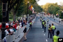 People and security line the parade route on 17th Street looking toward Constitution Avenue for Pope Francis in Washington, Sept. 23, 2015.