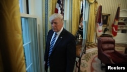 U.S. President Donald Trump stands in the Oval Office following an interview with Reuters at the White House in Washington, April 27, 2017. 