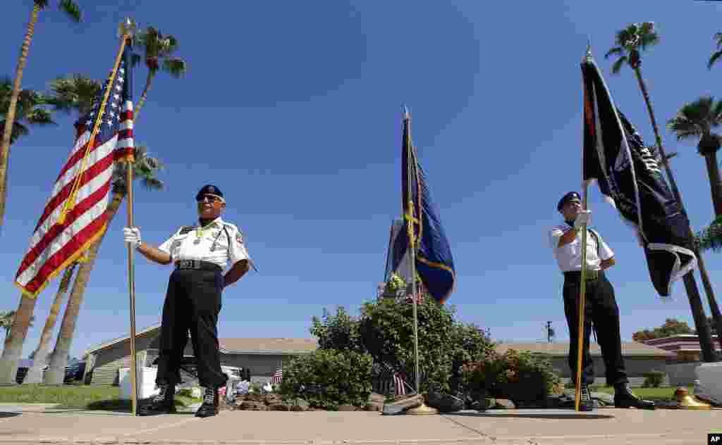 Members of the POW-MIA-KIA Honor Guard organization stand in front of a local mortuary keeping the late Arizona Sen. John McCain, Aug. 26, 2018, in Phoenix. 