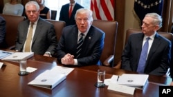President Donald Trump speaks during a cabinet meeting at the White House as Secretary of State Rex Tillerson, left, and Secretary of Defense Jim Mattis, right, listen, Oct. 16, 2017.
