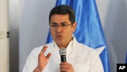 The President of Honduras, Juan Orlando Hernandez, announces his intention to run for another term, in Tegucigalpa, Nov. 9, 2016.