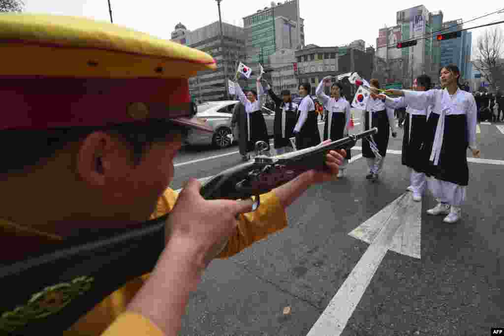 South Korean activists dressed as colonial-era Japanese soldiers reenact a crackdown of the independence movement during celebrations of the 98th Independence Movement Day in Seoul.