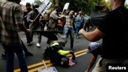 A man hits the pavement during a clash between members of white nationalist protesters against a group of counterprotesters in Charlottesville, Va,, Aug. 12, 2017. (REUTERS/Joshua Roberts)