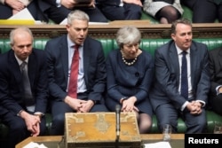 Britain's Prime Minister Theresa May reacts during the debate on extending Brexit negotiating period in Parliament in London, Britain, March 14, 2019.