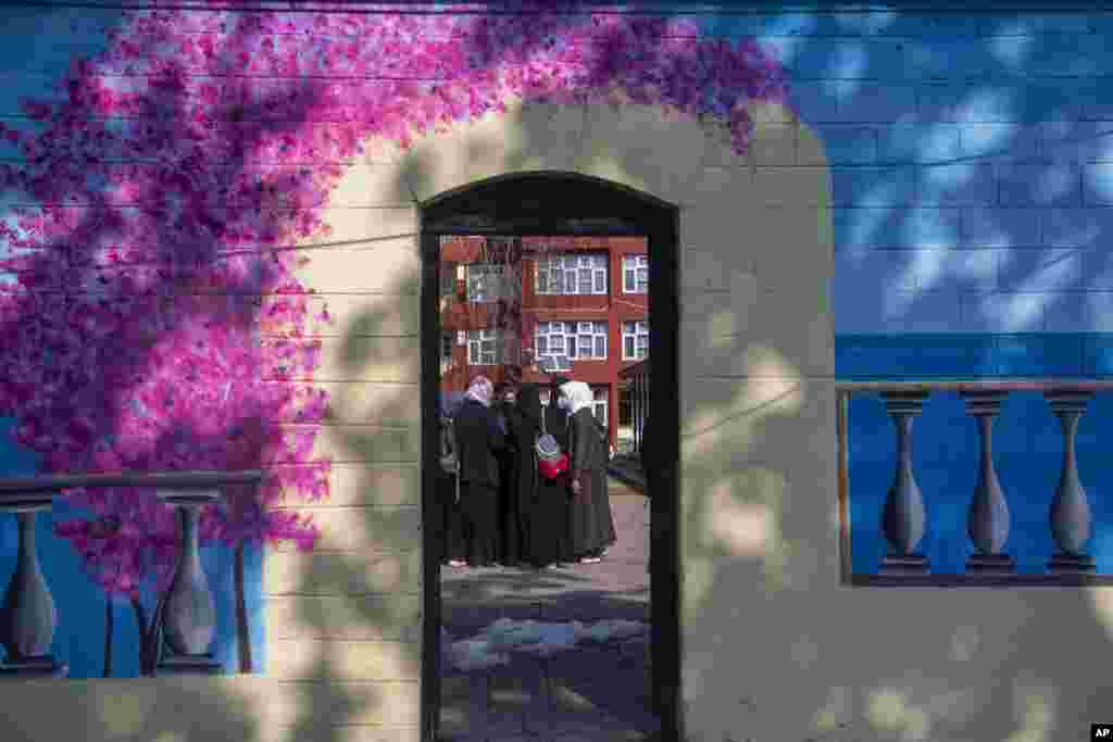 Kashmiri students assemble inside their campus as colleges reopened eleven months after being closed due to the coronavirus pandemic in Srinagar, Indian-controlled Kashmir.