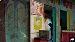 A hairdresser waits for customers in Kinshasa, Congo, Friday Dec. 28, 2018.