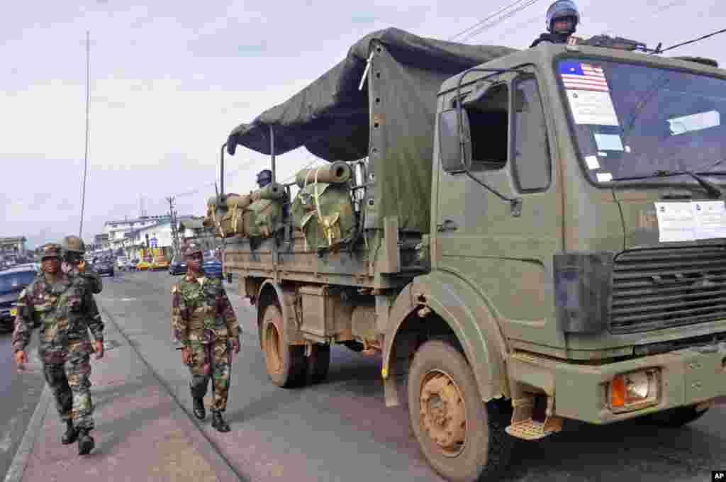 Liberian soldiers walk through the streets in an attempt to control public fears of the deadly Ebola virus, Monrovia, Liberia, August 1, 2014.