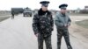 Ukrainian officers return after negotiations with Russian troops (L) at the Belbek airport in the Crimea region, March 4, 2014. 