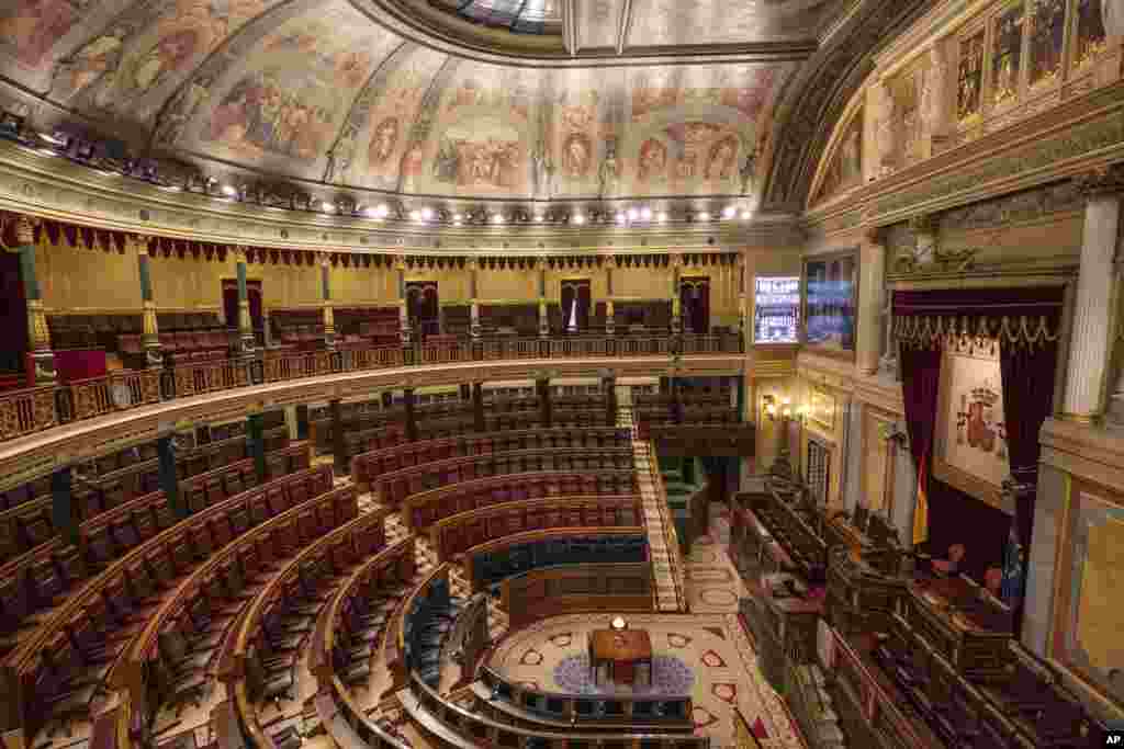 Empty seats are seen in the Spanish parliament&#39;s lower house in Madrid. The Spanish parliament&#39;s lower house has canceled its activities for a week after a lawmaker from the far-right Vox party tested was confirmed to have COVID-19.
