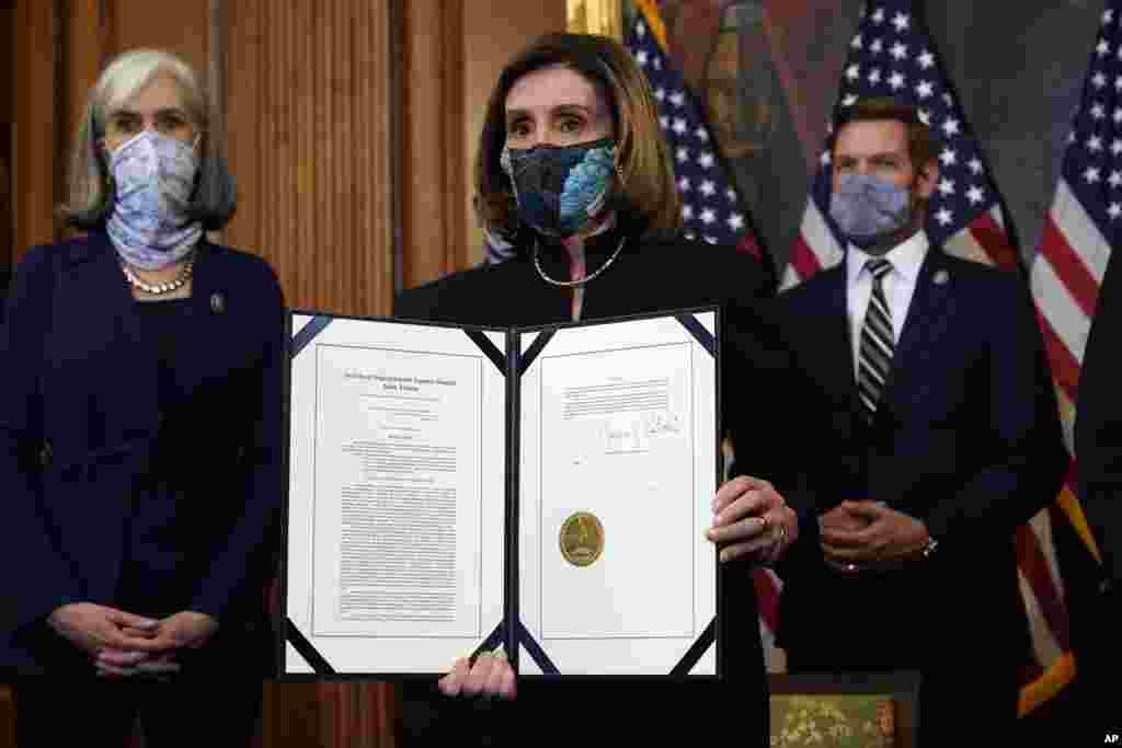 House Speaker Nancy Pelosi of California holds the signed article of impeachment against President Donald Trump in a ceremony before transmission to the Senate for trial on Capitol Hill, in Washington, D.C., Jan. 13, 2021.