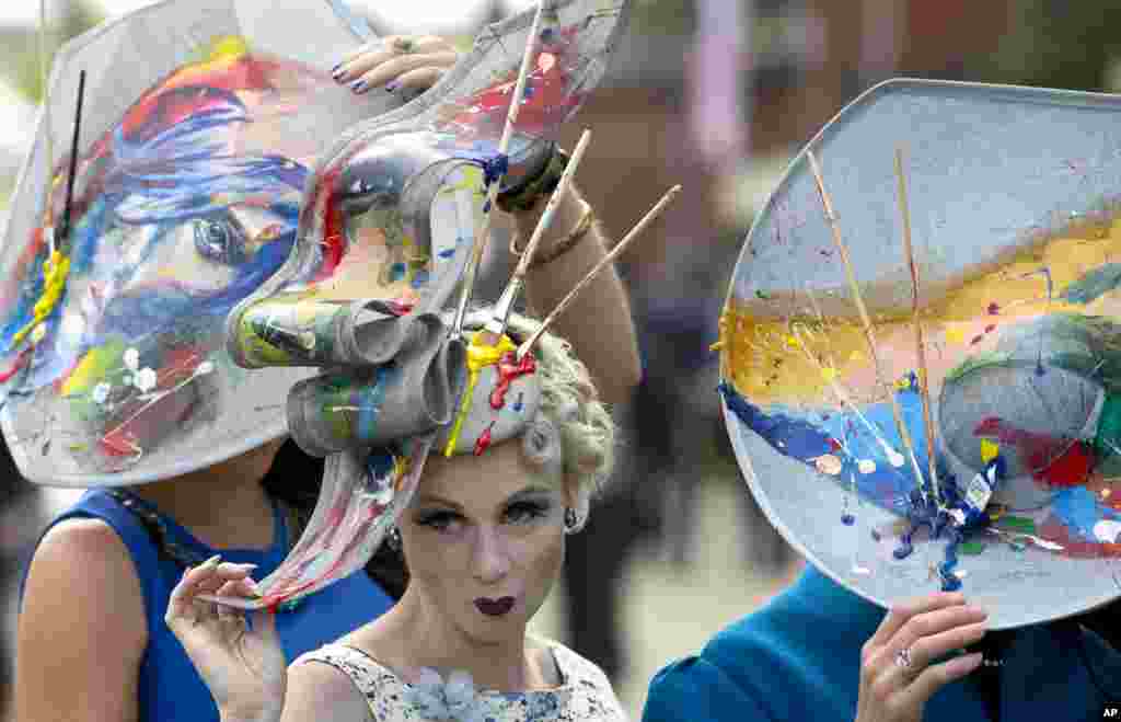 Constance Peach, center, poses with friends for photographers on the third day of the Royal Ascot horse racing meeting, which is traditionally known as Ladies Day, at Ascot, England.