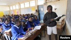 FILE - Pupils revise their class work without a teacher on the second week of a national teachers' strike, at Olympic Primary School in Kenya's capital Nairobi, September 9, 2015. 