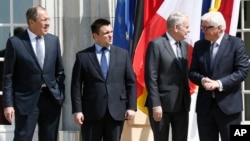 FILE - From left, Russia Foreign Minister Sergei Lavrov, Ukraine Foreign Minister Pavlo Klimkin, France Foreign Minister Jean-Marc Ayrault and German Foreign Minister Frank-Walter Steinmeier gather before talks in Berlin, Germany, May 11, 2016. 