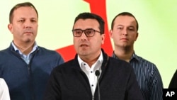 North Macedonia's Prime Minister Zoran Zaev, center, speaks at the party headquarters in Skopje, North Macedonia, Oct. 31, 2021. 