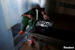 A fisherman brings fish to the auction at the port of Matosinhos in Portugal, May 28, 2018.