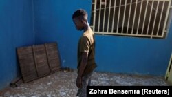 Fallou Diop, a 19-year-old horse jockey, prays at the Lambafar stable in Niaga, Rufisque region, Senegal, January 27, 2021. (REUTERS/Zohra Bensemra)