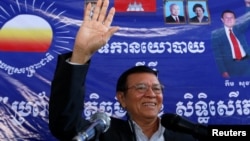FILE - Kem Sokha, leader of the Cambodia National Rescue Party (CNRP), greets his supporters at headquarters before he goes to register for next year's local elections, in Phnom Penh, Cambodia, Oct. 5, 2016.