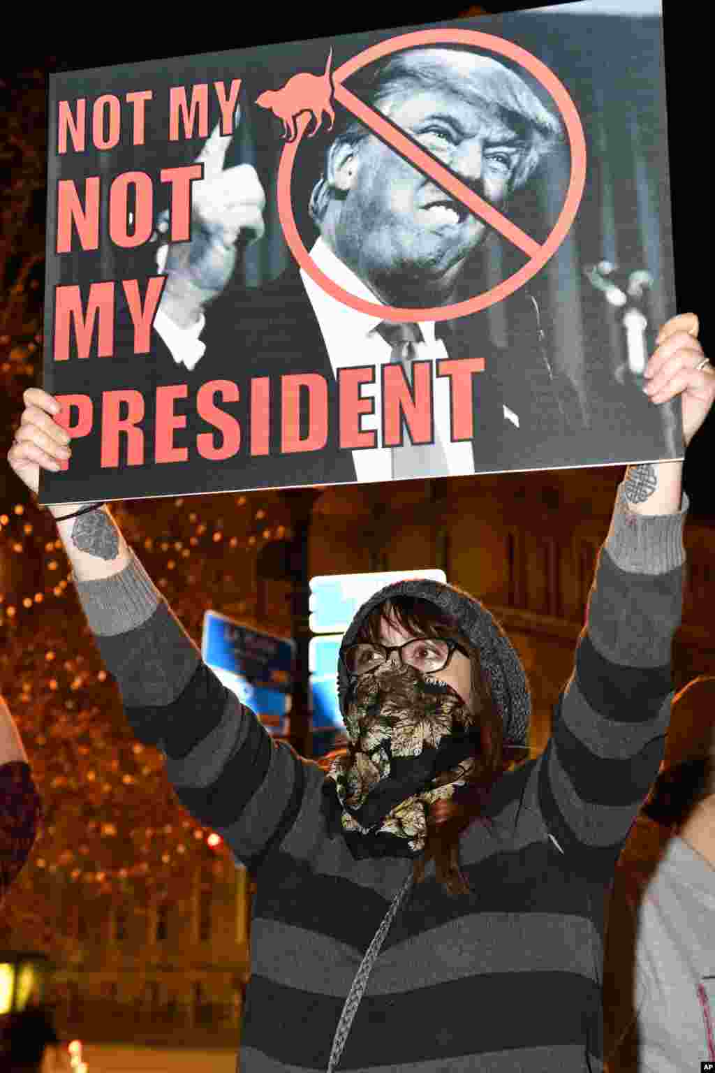  A protester holds up a sign in opposition of Donald Trump's presidential election victory, Nov. 10, 2016 at Jefferson Square Park in Louisville Ky. 