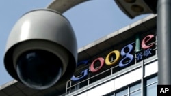 FILE -A surveillance camera is seen in front of the Google China headquarters in Beijing, China.