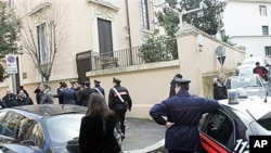 Carabinieri police officers stand guard outside the Ukrainian embassy where a false bomb alarm was reported, Rome, 23 Dec 2010