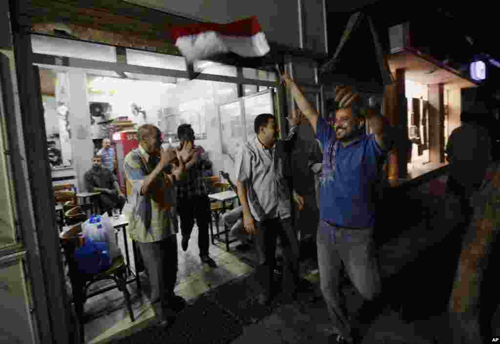 Egyptians celebrate at a tea house in Cairo&#39;s Zamalek district after Defense Minister Gen. Abdel-Fattah el-Sissi&#39;s announcement, July 3, 2013. Egypt&#39;s military has suspended the Islamist-backed constitution and called early elections. 