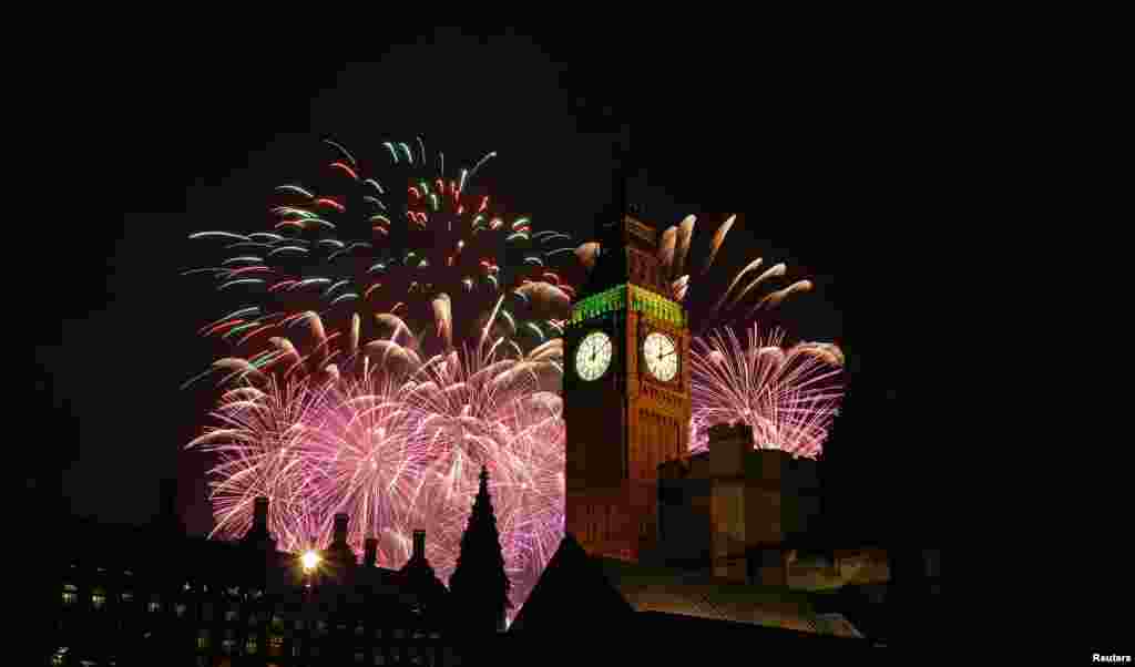 Fireworks explode behind the Houses of Parliament and Big Ben on the River Thames during New Year's celebrations in London, Jan. 1, 2015.