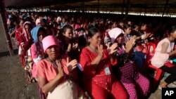 FILE PHOTO - Garment workers clap as they listen to Prime Minister Hun Sen speak at their factory outside of Phnom Penh, Cambodia, Wednesday, Aug. 30, 2017. 