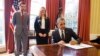 FILE - President Barack Obama signs an Executive Order, entitled “Planning for Sustainability in the Next Decade,” which will cut the Federal Government’s greenhouse gas (GHG) emissions over the next decade, March 19, 2015. Behind the president is Senior Adviser Brian Deese and Kate Brandt, Federal Chief Sustainability Officer. 