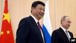FILE - Chinese President Xi Jinping smiles before a meeting with Russian leader Vladimir Putin in Ufa, Russia.