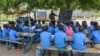 FILE - A teacher conducts his class under a tree in Moho, a village in the Northern Province of Cameroon, Sept. 16, 2016.