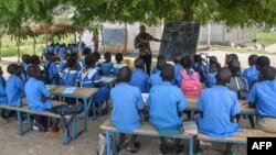 FILE - A teacher conducts his class under a tree in Moho, a village in the Northern Province of Cameroon, Sept. 16, 2016. In parts of Cameroon, teacher are on strike.