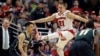 Travis Trice, kiri, berada di bawah Josh Gasser (21) di paruh kedua pertandingan bola basket kampus NCAA di kejuaraan turnamen Big Ten Conference di Chicago, Minggu, 15 Maret 2015. (Foto: AP / Nam Y. Huh )