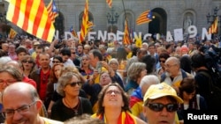 FILE - Catalan independence supporters are seen gathered in front of the Palau de la Generalitat (Government Palace) in Barcelona Sept. 27, 2014. 