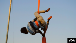 One of Hiccup Circus's aerialists gets into position to perform what's known as a 'drop'. (Elizabeth Paulat/VOA)