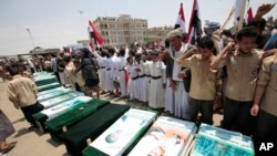 FILE - Yemeni people attend the funeral of victims of a Saudi-led airstrike, in Saada, Yemen, Aug. 13, 2018. Yemen's Shi'ite rebels are backing a United Nations' call for an investigation into the airstrike in the country's north that killed dozens of peo