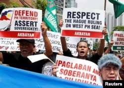 Members of the Akbayan activist group chant anti-China slogans as they march toward the Chinese consulate during a rally on the South China Sea dispute, in Makati, Metro Manila, in Philippines, July 12, 2018. Two years ago China lost a World Court arbitration case.