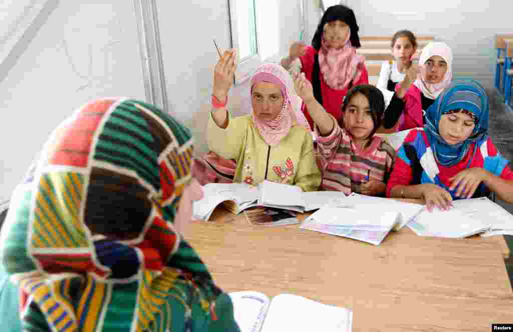 Syrian refugee children attend class at a new school at the Al Zaatri refugee camp in Mafraq, Jordan, near the border with Syria, June 4, 2013.