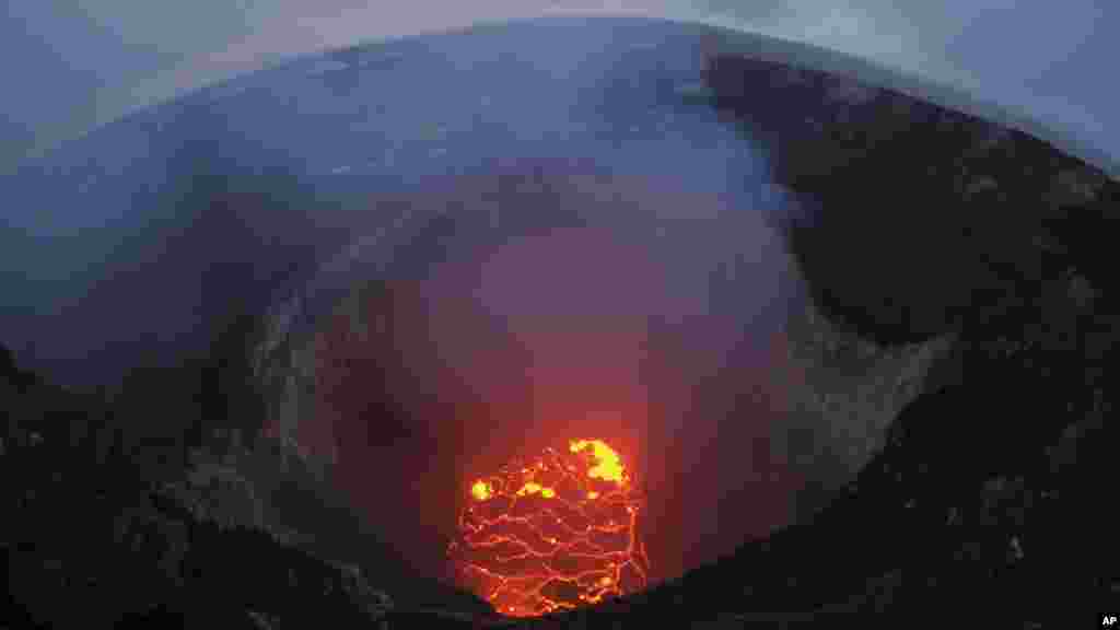 This May 6, 2018 photo provided by the U.S. Geological Survey shows the lava lake at the summit of Kilauea near Pahoa, Hawaii. Hawaii's erupting Kilauea volcano has destroyed homes and forced the evacuations of more than a thousand people.