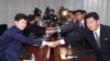 FILE - Lee Sang-min, chief of a South Korean delegation to a joint committee in charge of running the Kaesong Industrial Complex (l) shakes hands with his North Korean counterpart Pak Chol Su during a meeting to discuss minimum wage issues of North Korean