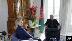 U.S. Secretary of State Hillary Rodham Clinton (L) holds private talks with Afghan President Hamid Karzai during an international conference on the future of Afghanistan, in Bonn, Germany, December 5, 2011.