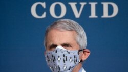 (FILES) In this file photo White House Chief Medical Adviser on Covid-19 Dr. Anthony Fauci listens as US President Joe Biden (out of frame) speaks about the 50 million doses of the Covid-19 vaccine shot administered in the US during an event commemorating