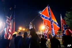 Demonstrators who supports keeping Confederate era monuments protest before the Jefferson Davis statue was taken down in New Orleans, May 11, 2017.